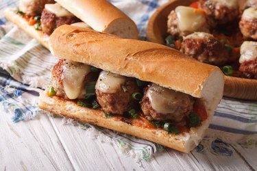 sandwich with meatballs and cheese close-up on the table