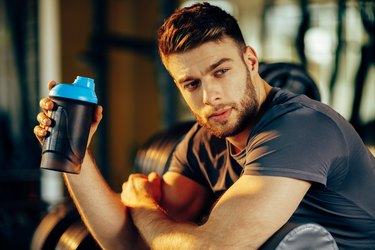 Handsome man resting during a workout at the gym