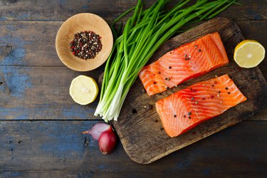 Salmon, onion and spice on cutting board