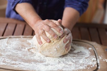 Hands kneading dough for bread