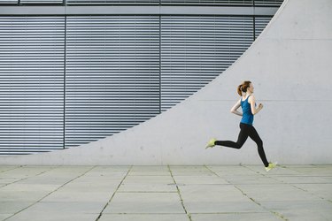 Woman running in front of a building