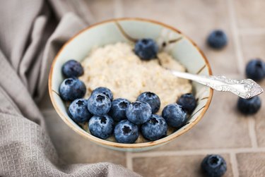 Close-up of oatmeal porridge with fresh blueberries for breakfast
