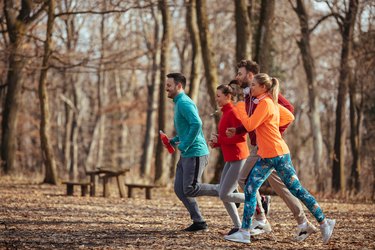 Group of friends jogging together outdoors