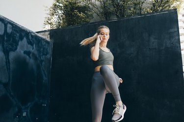 Mobility Training: Fit Blonde Woman Doing a Dynamic Exercise Outdoors