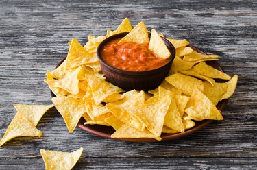 Nachos corn chips with spicy tomato sauce.