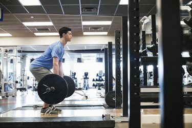 Man doing deadlifts in fitness center