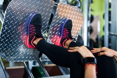 Close up shoes of a fit young woman doing leg