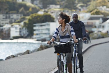 Couple using rental bikes to get health benefits of biking