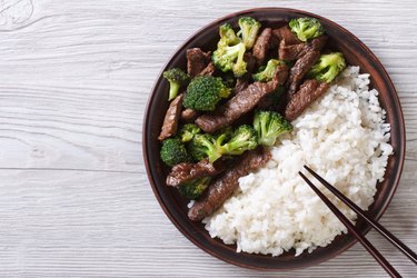 beef with broccoli and rice on the table. top view