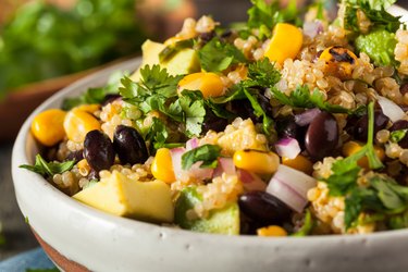 a close up photo of a bowl of homemade Southwestern Mexican Quinoa Salad with corn, quinoa, red onions, cilantro and avocado
