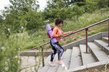 Woman walking to yoga class.