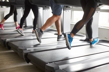 Unrecognized people running on treadmill.