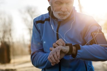 Senior Man using Smart Watch measuring heart rate