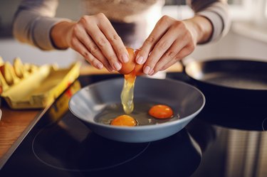 Close up of a woman cooking eggs