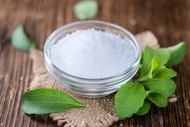 Old wooden table with Stevia Granules (selective focus)