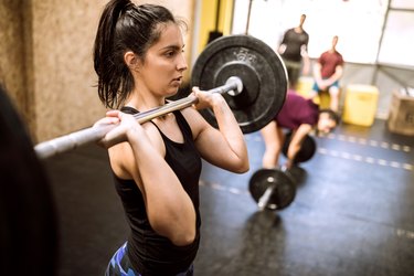 Young woman Preparing for Weightlifting