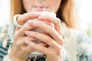 Woman drinking onion tea for cold