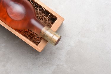 A bottle of Rose wine in a wood box