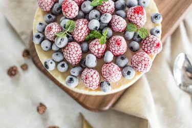 Frozen berries on cheesecake on a table.