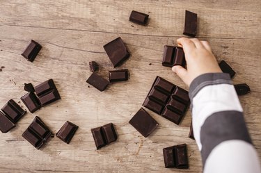 hand taking piece of chocolate