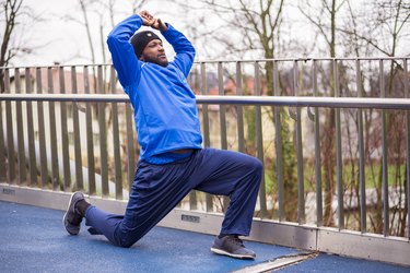 Runner doing a hip stretch outside