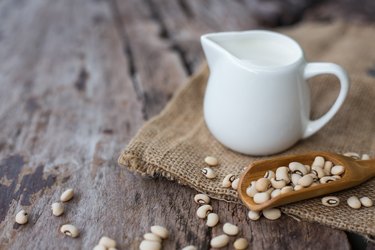 Soy milk and soy bean on wooden background