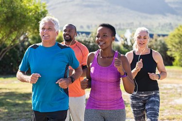 group of older adults running outdoors in the park