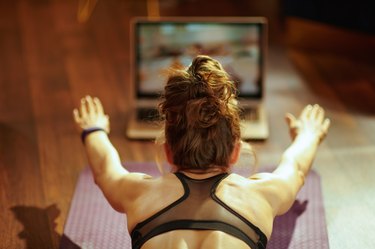 woman playing fitness game on internet while doing her workout