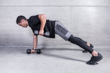 Man doing a renegade row exercise with dumbbells during an upper body workout