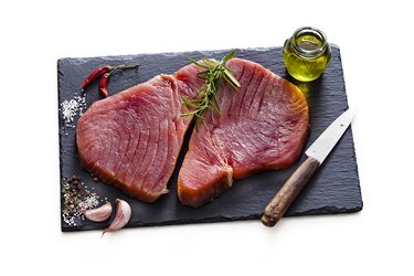 Two raw tuna steaks isolated on white background