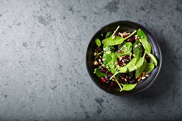 Spinach salad with dried cranberries and pomegranate seeds