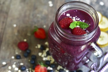 A fiber shake made with berries and bananas in a Mason jar