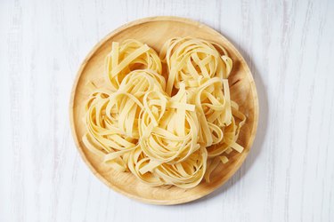 Fresh, uncooked dried pasta on a plate