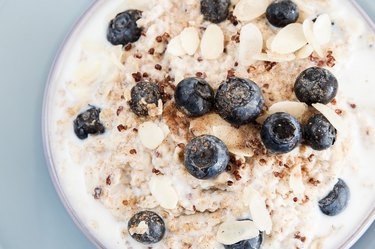 Close view of quinoa oatmeal with almond milk, blueberries and slivered almonds