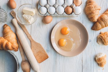 Cooking baking ingredients and eggs isolated on table