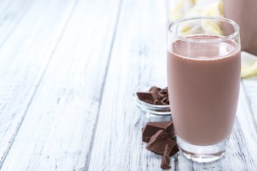 Cold Chocolate Milk on a white wooden table