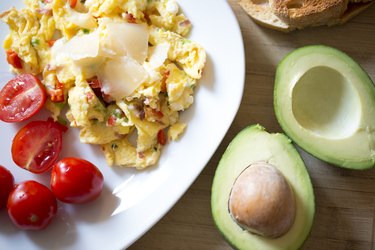 Breakfast with scrambled eggs, vegetables and avocado for a low carb and sugar diet