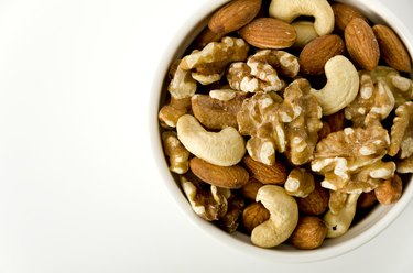 mix of nuts in a cocotte on a white background.