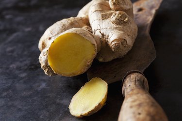 Sliced ginger root on a wooden cutting board