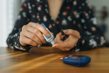 person with diabetes doing blood glucose measurement