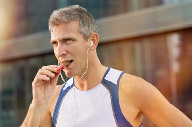 Fitness Man Eating Protein bar