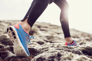 Close up of trainers running through mossy terrain trying to get rid of cankles