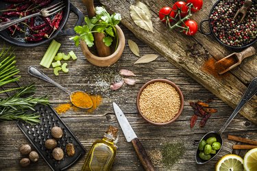 Spices and herbs shot from above on rustic wooden table