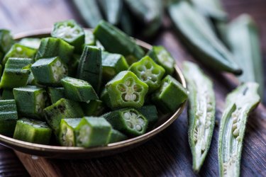 Farm fresh oxalate-rich okra on wooden board