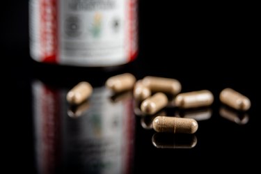 Cinnamon supplement pills or capsules on a black background