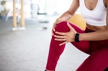Close up of young fit and active woman with knee pain