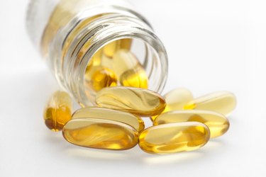 Omega 3 fish oil capsules and bottle