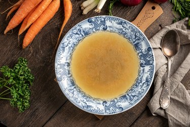 Chicken bone broth in a blue vintage plate