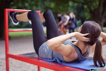 Fit young woman working out in a park