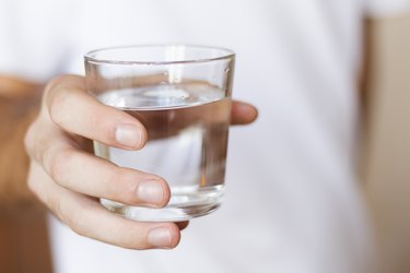 glass of fresh water in hand